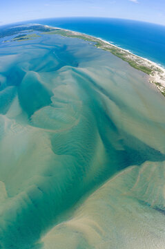 Currents from the North Atlantic Ocean continuously shape the sand banks and beaches of Cape Cod, Massachusetts. The entire peninsula is in constant movement due to its geologic makeup of mostly sand.