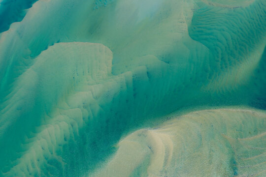 Currents from the North Atlantic Ocean continuously shape the sand banks and beaches of Cape Cod, Massachusetts. The entire peninsula is in constant movement due to its geologic makeup of mostly sand.
