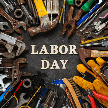 Group of used and worn work tools with Labor day text. Symbolic of the labor movement and pride working class or blue collar workers. Celebrate Labor Day or International Workers Day.