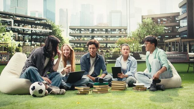 Woman student sits on the grass near a tablet and discusses project notes with diverse classmates at a university campus, supporting peer tutoring, study teamwork and international group learning.