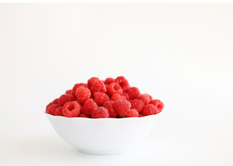 A close‑up of a red raspberry on a white background. © Мария Чепрасова