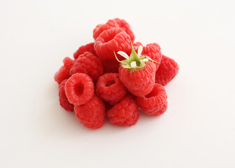 A close‑up of a red raspberry on a white background. © Мария Чепрасова