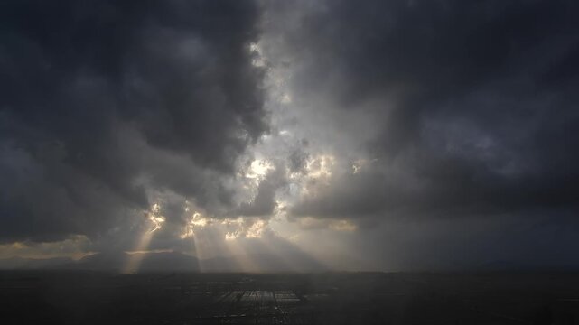 Time lapse black storm clouds over flooded plains after rain creating dramatic weather mood.