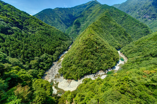 High-angle view of the Hinoji Valley where the Iya River meanders in the shape of the Hiragana character 'Hi' in Tokushima, Japan.
