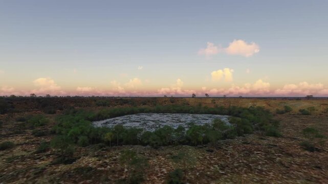 Circular aerial drone view at sunset of Wolfe Creek Meteorite Crater. Australia