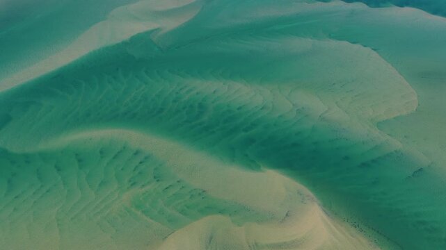 Currents from the North Atlantic Ocean continuously shape the sand banks and beaches of Cape Cod, Massachusetts. The entire peninsula is in constant movement due to its geologic makeup of mostly sand.