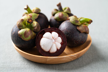 Fototapeta premium Fresh mangosteen on wooden plate, Tropical fruit in Thailand