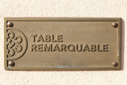 Villefranche, France - February 15, 2017: Table remarquable logo on a wall. A remarkable table denotes a culinary distinction in the French Gault&Millau guide