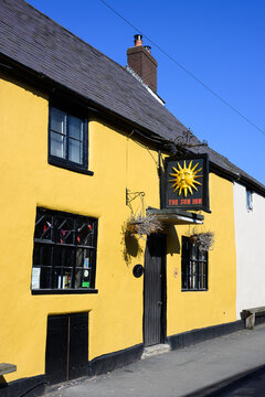 Clun, Shropshire, UK - March 19, 2026; Yellow facade of The Sun Inn in Southwest Shropshire town of Clun with classic sign