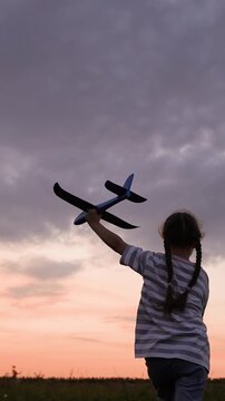 baby girl playing airplane pilot, kid dream flying, kid superhero, Child with Toy Plane at Sunset, Dreaming of Flying, Girl Playing in the Field, Childhood Adventure Outdoors, Imagination Takes Flight