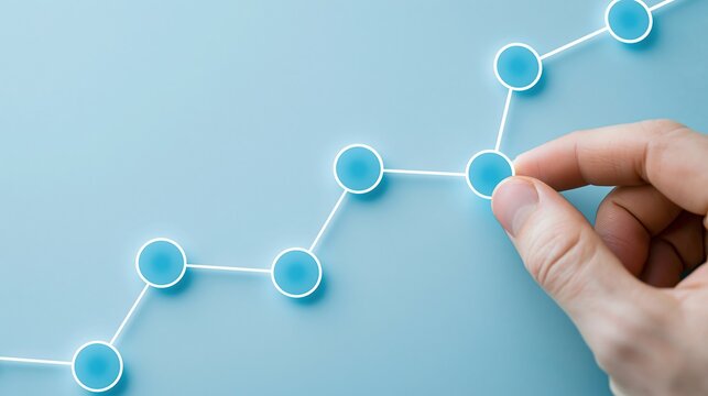 Hand touching glowing blue nodes connected by white lines on a light blue background representing data flow or network growth