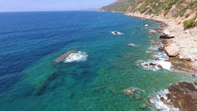 Chile Coast coastline meets turquoise water, rocky cliffs and quiet sandy coves in scenic light.