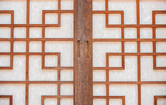 Close up of traditional Korean hanji sliding doors with geometric wooden latticework in South Korea.