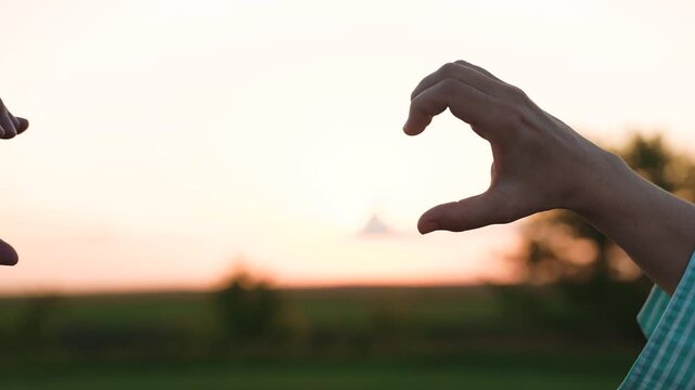 woman man showing heart with hands, lovers couple happy man woman traveler sunset, female male freedom, people outdoors nature, close emotional bond, peaceful loving silence, authentic love moment