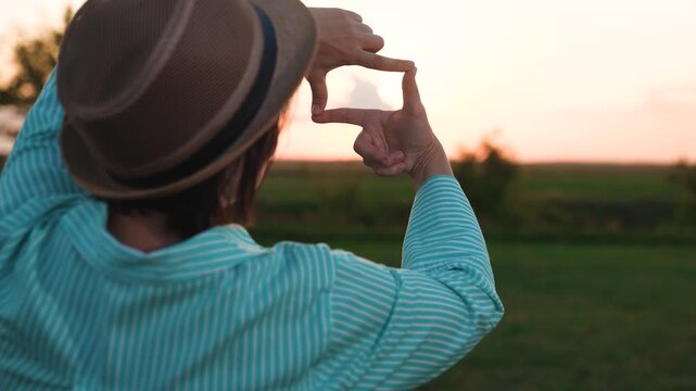 woman showing frame sign with hands, happy woman traveler sunset, female freedom, people outdoors nature, people at sunset, looking through frame, building life together, abstract creative background