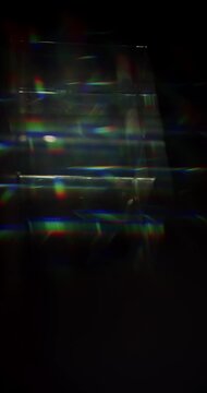 Light ray shining through a prism for angled beams of sparkling shine in brilliant colors. Swirling reflective glass with beaming lights creating visual effect of a brilliant dazzling rainbow. Loop.
