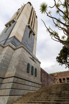 A towering stone memorial rises above a wide staircase and classical columned entrance at Pukeahu National War Memorial Park in Wellington, New Zealand