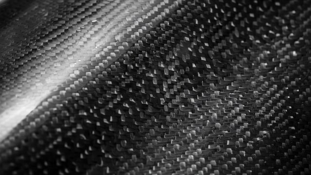 Macro close-up of black carbon fiber weave texture