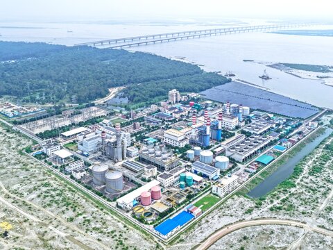 Aerial view of Sirajganj Power Station featuring industrial buildings, storage tanks, and chimneys near the Jamuna River in Sirajganj District, Rajshahi Division, Bangladesh.