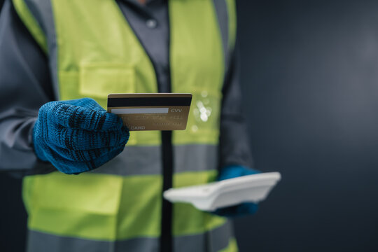 Industrial payment material purchasing concept construction worker holding credit card company expense account supply chain finance procurement logistics transaction warehouse corporate funding