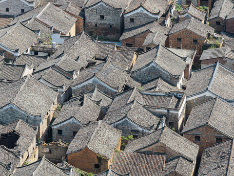 Aerial view of the traditional grey-tiled rooftops of Shanggantang Village, showcasing historic architecture and narrow alleyways in Yongzhou, Hunan, China.