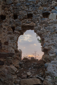 Ancient Stone Ruins with Arched Doorway at Sunset