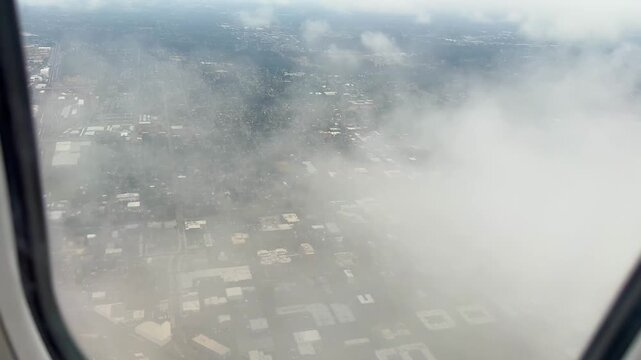 Portland Oregon View from Airplane Window through Clouds 