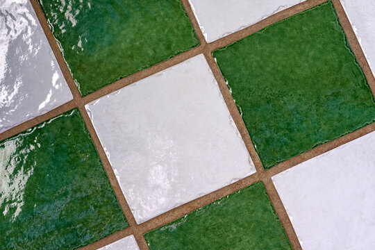 Detail of the patterns on a green and white tiled floor