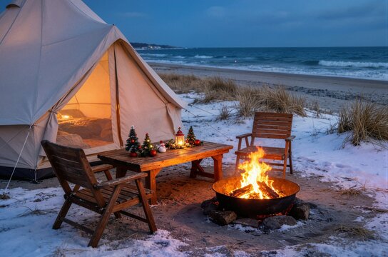 Glamping bell tent with campfire and decorated table on snowy beach ideal for winter holiday coastal travel promotion