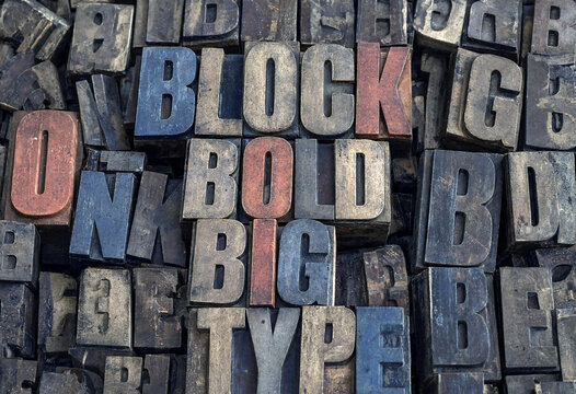 Vintage wooden printing blocks with bold big type letters arranged creatively for display