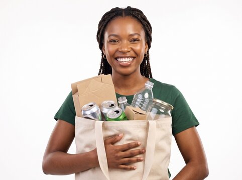 Smiling woman holding reusable bag filled with recyclable materials like plastic bottles aluminum cans and glass jars Isolated on White Background