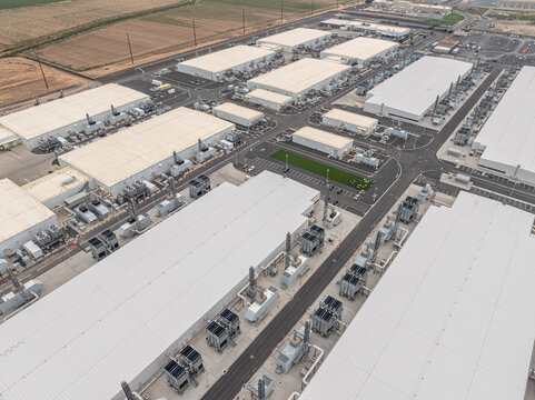 Aerial view of the Vantage Data Centers facility featuring large industrial buildings, cooling units, and paved access roads in Quincy, Washington, United States.