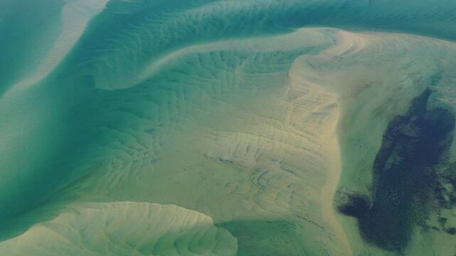 Currents from the North Atlantic Ocean continuously shape the sand banks and beaches of Cape Cod, Massachusetts. The entire peninsula is in constant movement due to its geologic makeup of mostly sand.