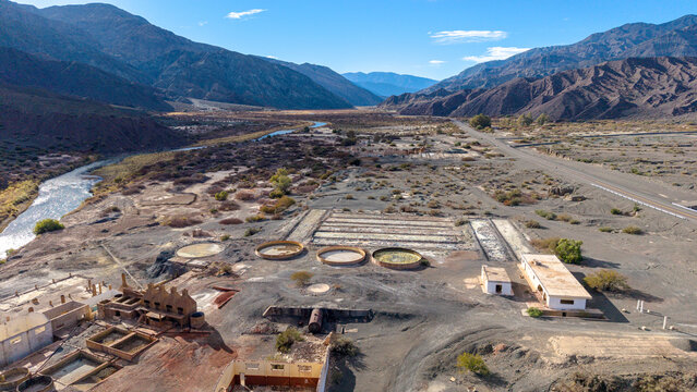 Aerial view of Ruinas de Planta de Sulfato de Aluminio showing the historic industrial structures, circular tanks, and surrounding arid landscape in Calingasta, San Juan, Argentina.