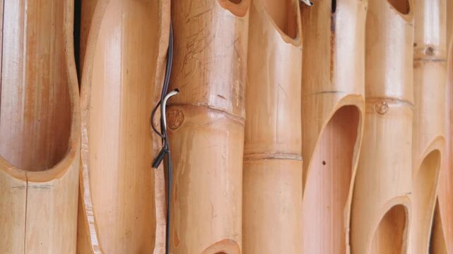 Close up view of vertical cut bamboo stalks creating a natural wall texture.