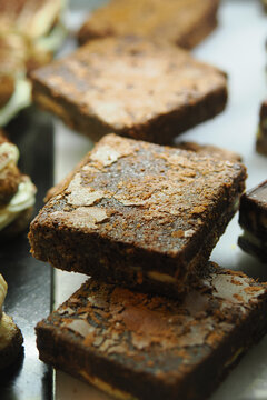 Brownies on display at a bakery in the afternoon