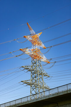 electricity pylon near the airport painted in red and white at the top to indicate danger to the landing and starting aircrafts