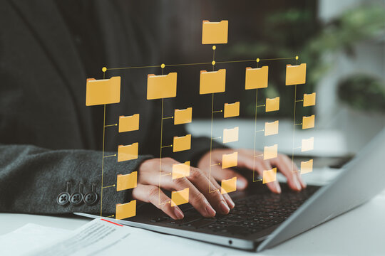 Folder hierarchy structure and document management system DMS. Businesswoman using laptop computer for saving and classifying files.