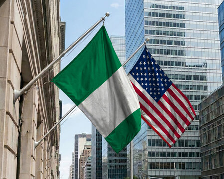 Nigeria and United States crossed national flags waving against a blue sky, representing bilateral relations and diplomacy.