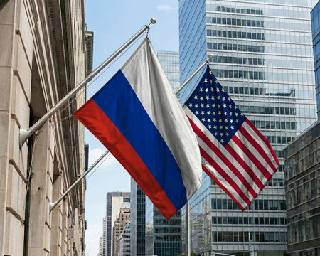 Russia and United States crossed national flags waving against a blue sky, representing bilateral relations and diplomacy.