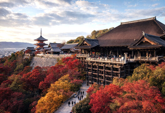 Majestic traditional japanese temple surrounded by vibrant autumn foliage on a scenic hillside location