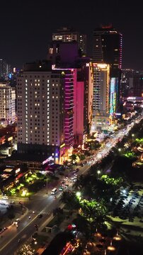 Vertical Aerial View Above Waterfront Road Traffic and Buildings Night Da Nang Vietnam