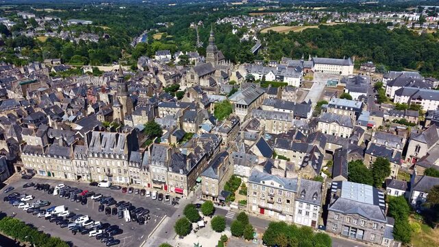 Drone panorama of Dinan cityscape with Duguesclin square and Clock Tower aka Tour de l'Horloge near Basilica of Saint-Sauveur and the iconic Viaduct with the Rance River in back, Cotes-d'Armor, France