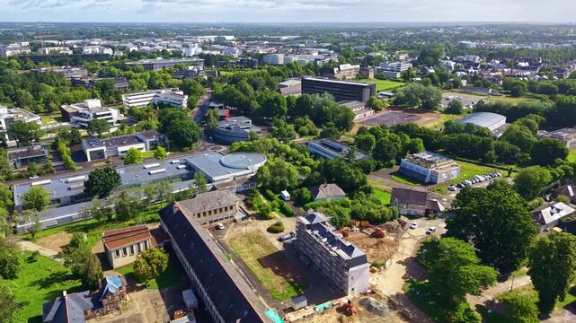 Elevated drone shot of distant Rennes cityscape with Pontchaillou neighborhood in foreground, Ille-et-Vilaine, France