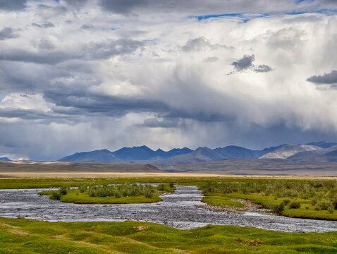 Valley of the Yustyd River.  In the background are mountains under a stormy sky. Altai republic.