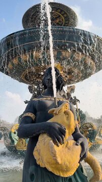 Close-up of ornate fountain statue with flowing water in a Paris city square