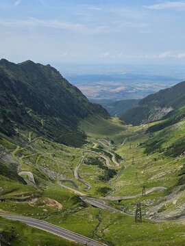 Scenic view of Transfagarasan mountain pass winding down into a deep valley, Romania