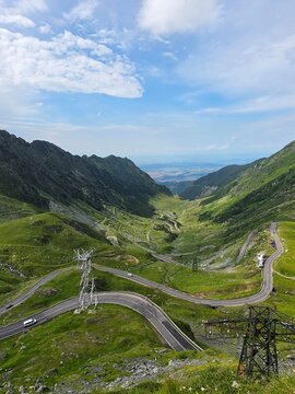 Scenic Transfagarasan mountain road with hairpin curves under blue sky, Romania