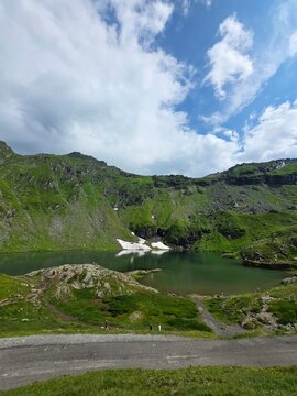 Scenic view of Balea glacial lake with tourists from a roadside viewpoint, Romania