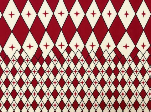 Seamless pattern with red and cream diamond shapes and star icons